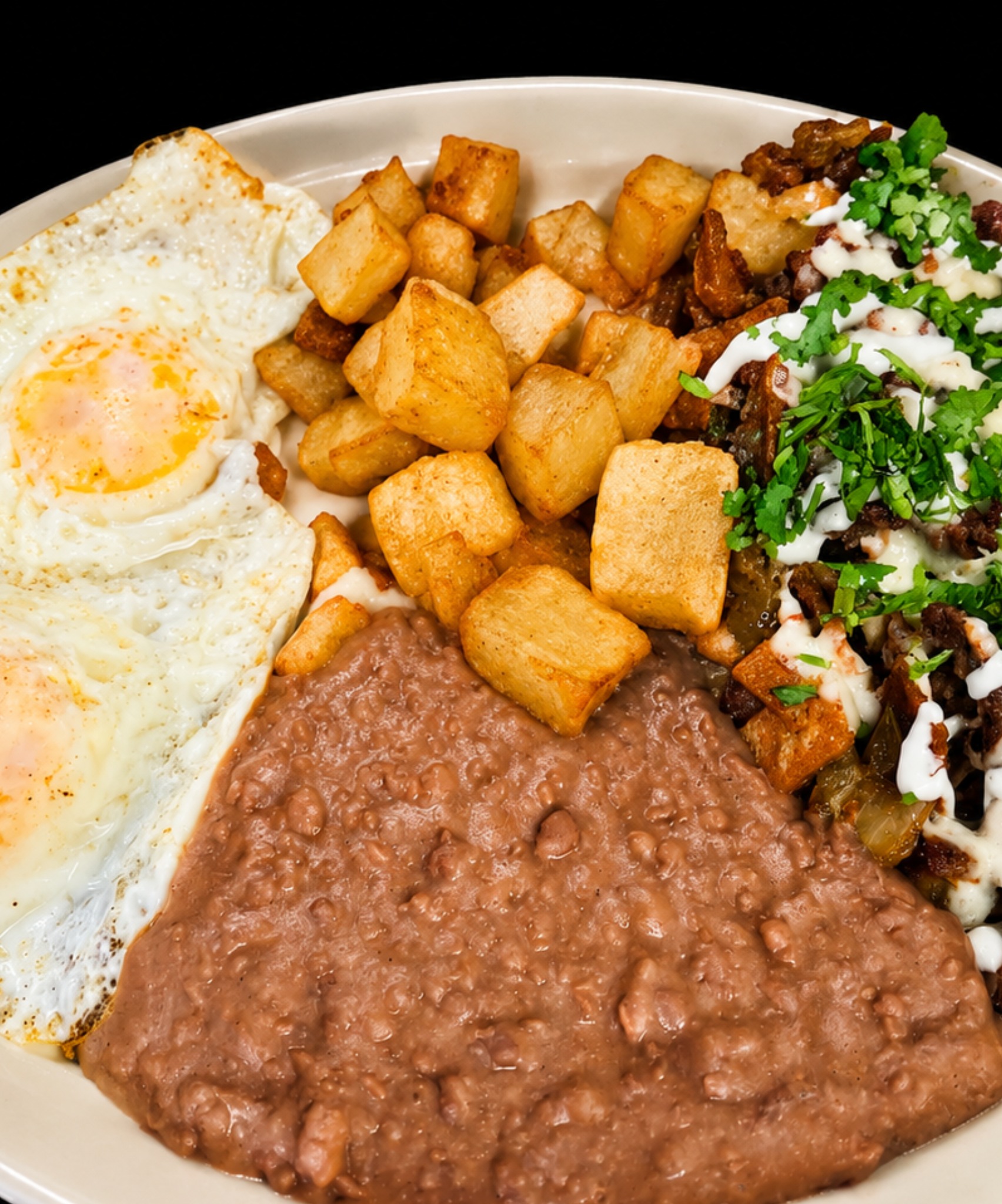 Breakfast plate with eggs, beans and potatoes